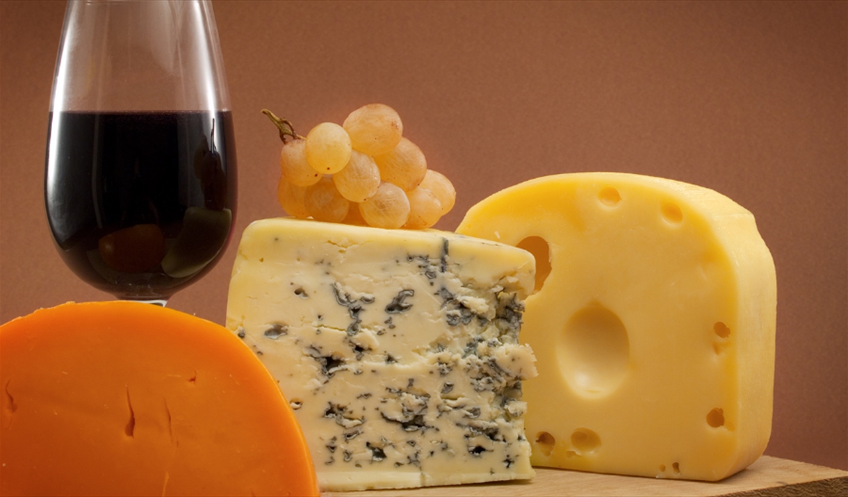 Selection of cheeses with a glass of red wine