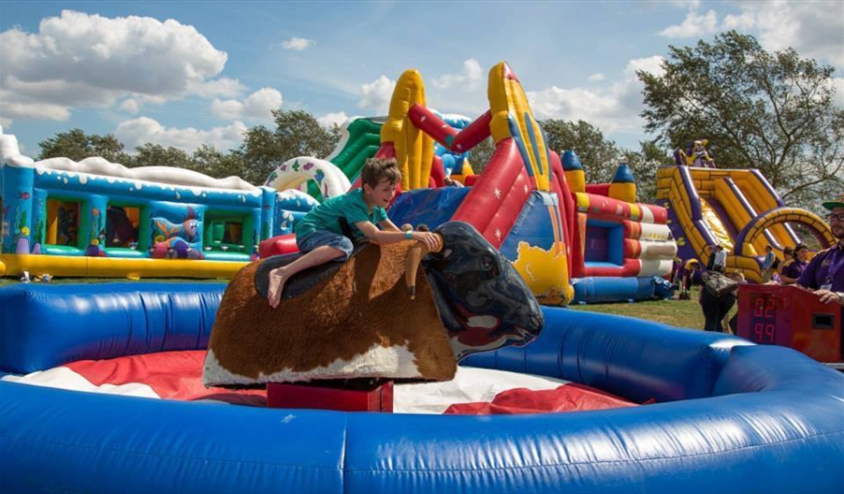 Inflatable fun day at Maldon, including child on bucking bull