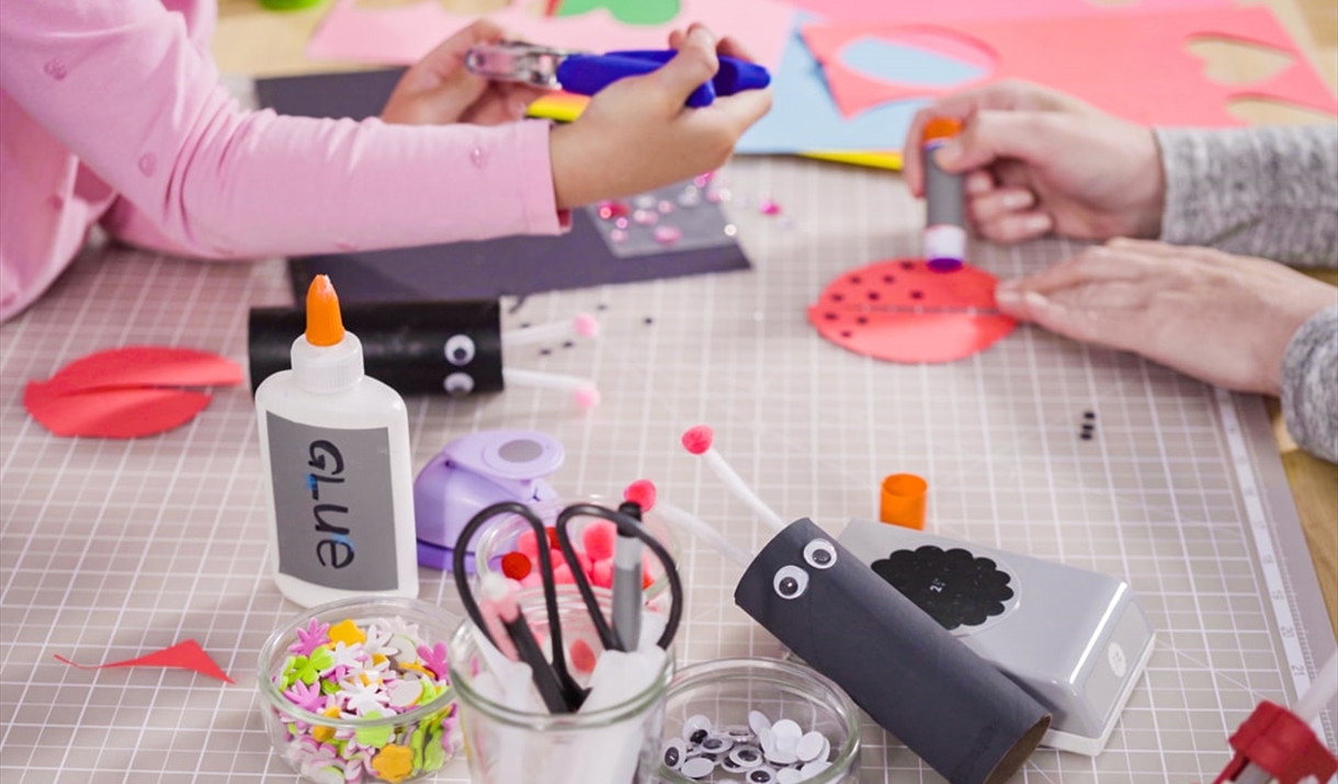 Two children at work on a craft table