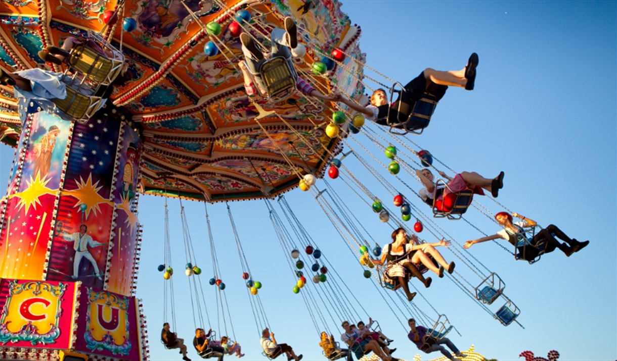 People riding on a fairground ride.