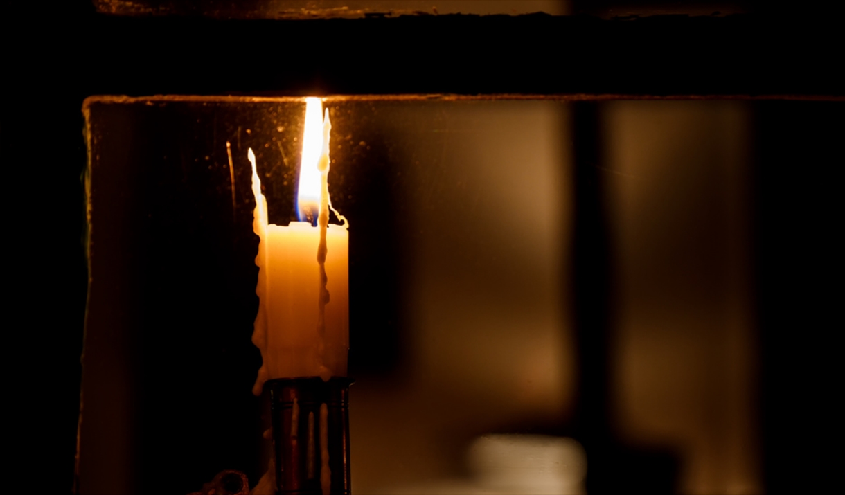 Candle burning on a windowsill