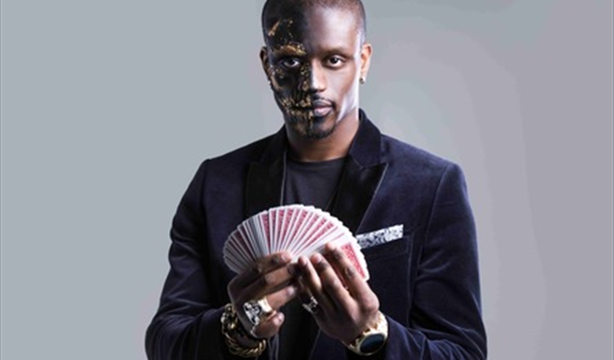A man holds up a deck of cards