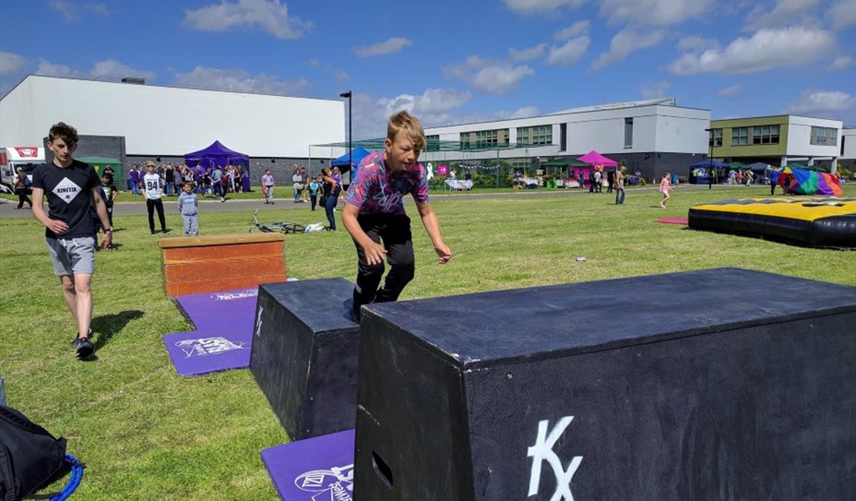 Child vaulting over a box.