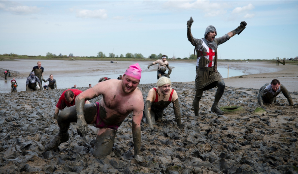 A group of racers crawling through the mud