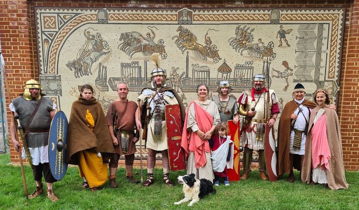 Roman re-enactors in front of a modern day mosaic