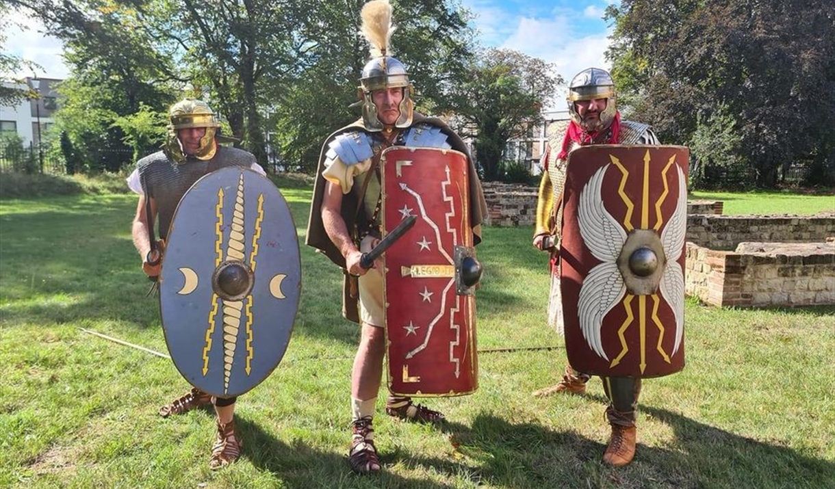 Three re-enactors dressed as Romans