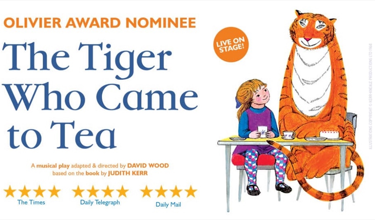 The Tiger who came to tea. Tiger sitting at a table with a young girl