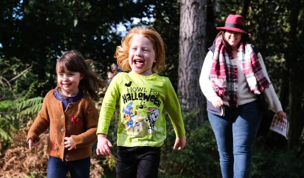 Woman and two children walking happily outside