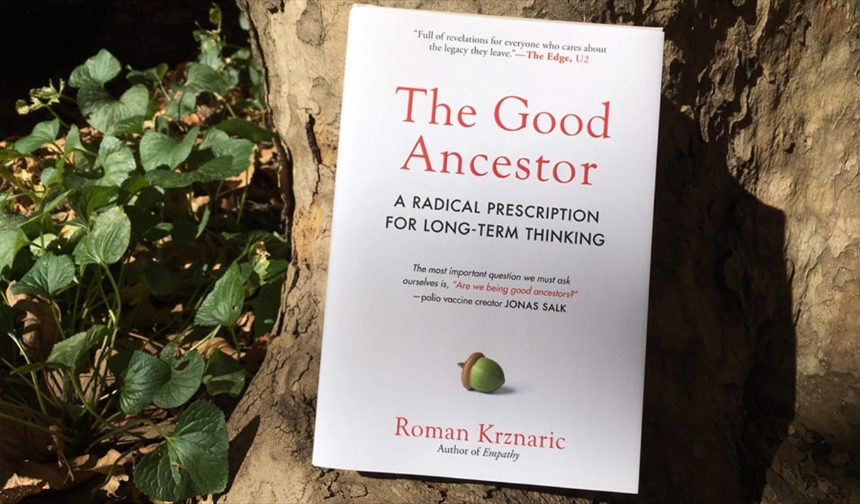 A copy of "The Good Ancestor" propped against a tree