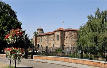 a view of Colchester Castle through the gates of Cowdray Crescent
