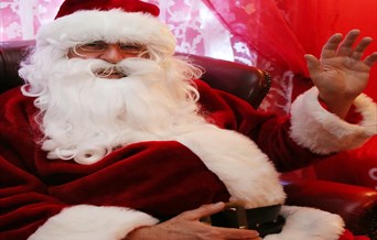 Father Christmas is smiling and waving