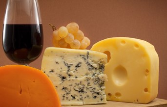 Selection of cheeses with a glass of red wine