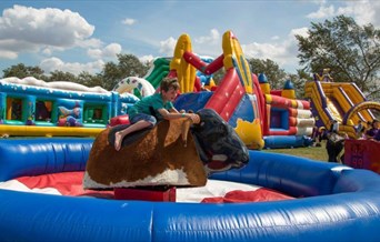 Inflatable fun day at Maldon, including child on bucking bull
