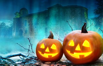 A graphic of the Castle with two pumpkins in teh foreground