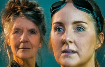 Close ups of two women. One, older, looks at the camera. One, younger, wears swimming goggles.