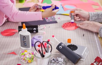 Two children at work on a craft table