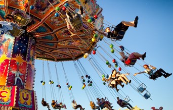 People riding on a fairground ride.