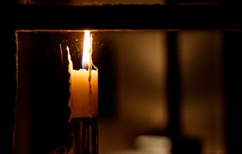 Candle burning on a windowsill