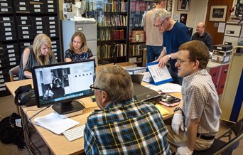 Volunteers scanning and digitising photos of jazz musicians