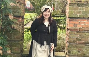 A tour guide in costume as 'the jailer's wife'