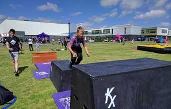 Child vaulting over a box.