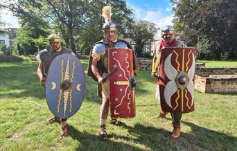 Three re-enactors dressed as Romans