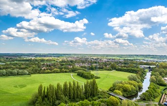 Aerial view of the showground site in River Lee Country Park showing large grass areas, tree and canal.