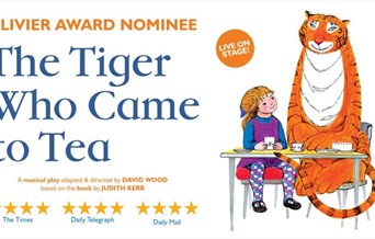 The Tiger who came to tea. Tiger sitting at a table with a young girl