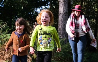Woman and two children walking happily outside