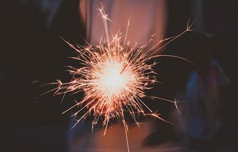 Sparkler glowing pink on firework night