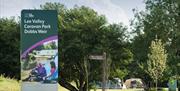 front entrance sign for Lee Valley Caravan Park Dobb Weir located on a  grassy bank