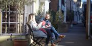 Couple drinking coffee outside cafe