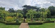 The kitchen garden path leading to a small ornamental pond