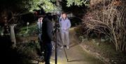 Presenter being filmed in the dark at Myddelton House Gardens