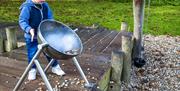 Child playing the drum on the Stick Man trail