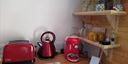 glamping pod, accommodation, holiday, uk, toaster, kettle, coffee machine, inside pod, shelving, condiments