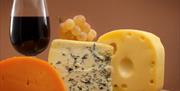 Selection of cheeses with a glass of red wine