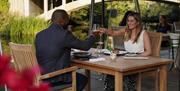 A couple eating outside at Talbooth restaurant