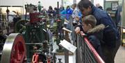 Man and boy looking at equipment at the Museum of Power