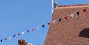 Saffron Walden Tourist Information Centre welcomes all visitors. Here, the Pride flag is flying above the Town Hall