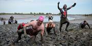 A group of racers crawling through the mud