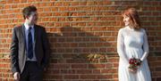 Couple against windmill brick backdrop