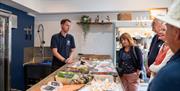 Group of guests in fishmongers shop