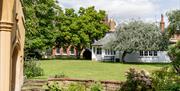 A walled garden with grass and trees