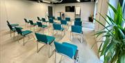 Photograph of a meeting room set up in theatre style.