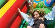 Kids having fun on a bouncy castle