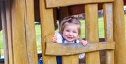 Little girl looking through a window frame