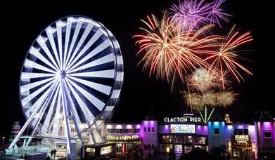 Clacton Pier fireworks and big wheel lit up at night