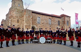 The Essex Caledonian Pipe Band pose in full tartan, outside Colchester Castle.