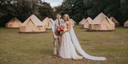 Couple against the glamping village for guest overnight stays